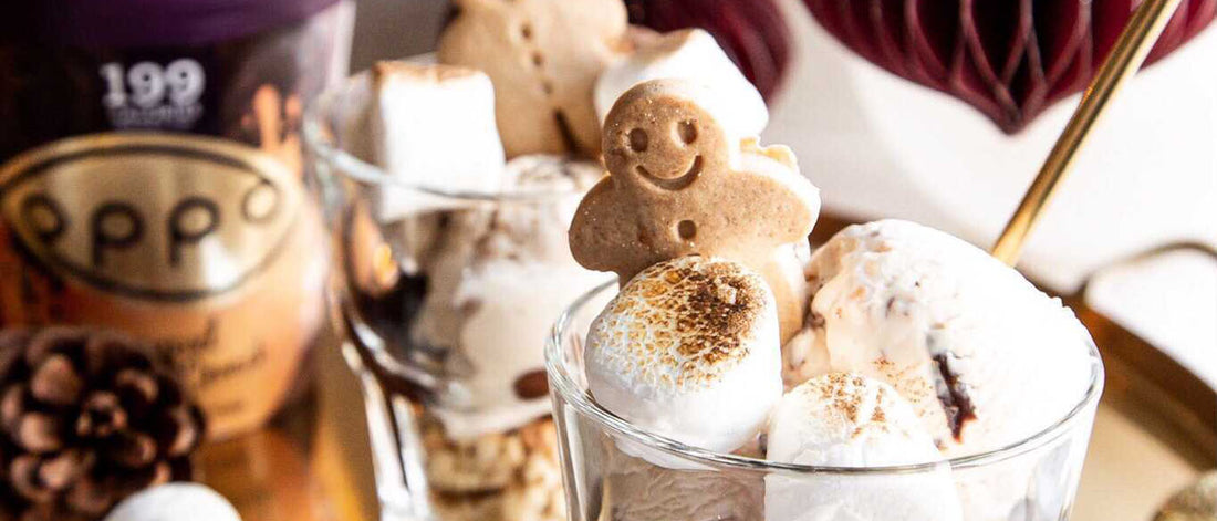 Caramel Cookie Melt Ice Cream Tub With Glasses Full Of Ice Cream, Marshmallows & Gingerbread Persons
