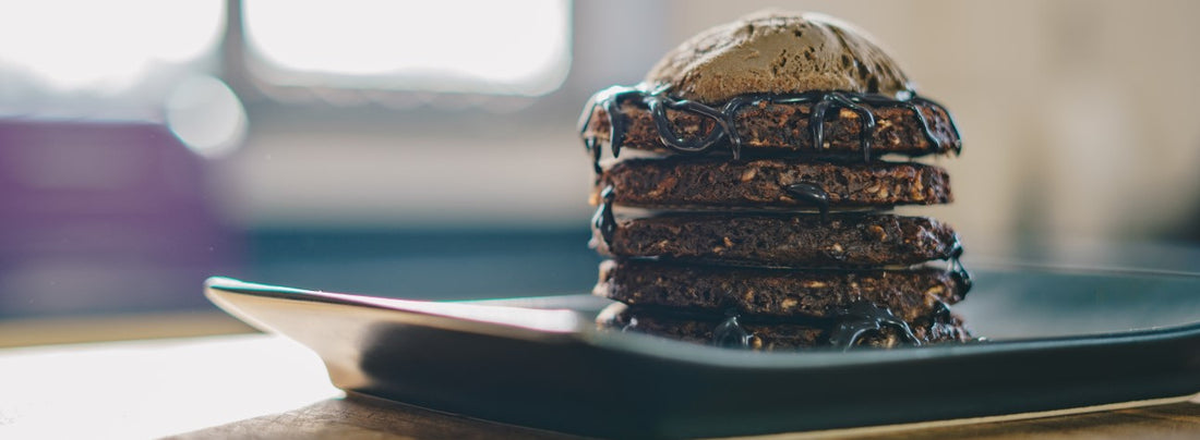 Stack Of Chocolate & Banana Pancakes With A Scoop Of Colombian Chocolate & Hazelnut Ice Cream On Top